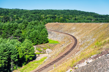 Fototapeta na wymiar A railroad track along an earthen dam