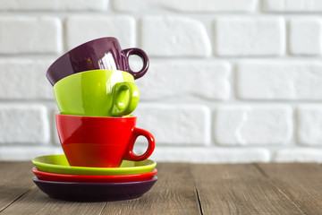 Tea, coffee cups stacked. Neutral background. Space for text.
