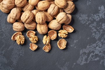 Walnut on black table, with copy space. Top view.