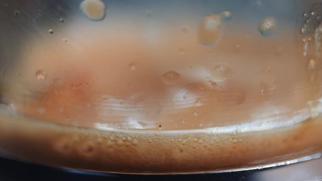 Frothy Espresso Coffee Slowly Fills a Glass
