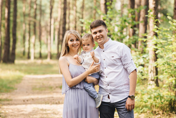 Fototapeta premium Happy young family spends time together in nature.