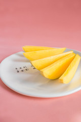 Naklejka na ściany i meble Mango fruit and mango slices on the white plate.