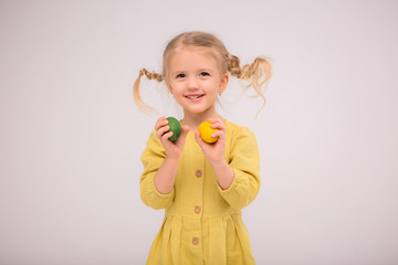 Teen girl juggles eggs and happily smiles, Copy space,baby girl with Easter eggs,concept of Easter