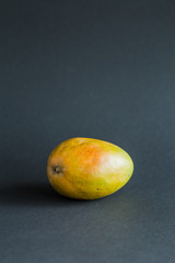 Mango. Tropical Fruits. On a black background. Copy space.