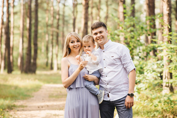 Happy young family spends time together in nature.