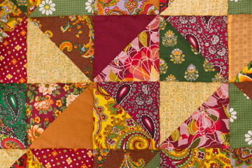 Fabric texture, quilt  with flowers and geometric patterns. Textile background
