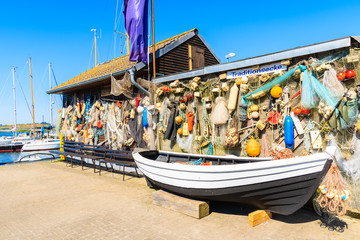 Fototapeta na wymiar GAGER PORT, RUGEN ISLAND - MAY 29, 2018: Old fishing boat and traditional houses in Gager port, Ruegen island, Baltic Sea, Germany. Fishery is still one of major industries in this region.