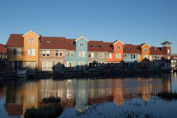Fototapeta na wymiar Famous Dutch cityscape, Reitdiephaven street with traditional colorful houses on water, Groningen, Netherlands, This buildings inspired by Scandinavian homes