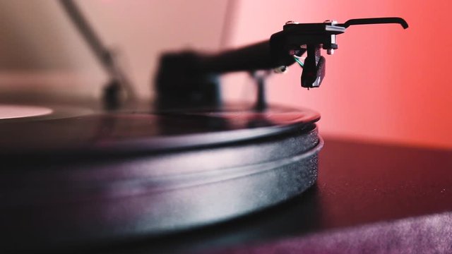 Turning on a turntable and playing a vinyl record