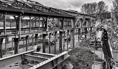 Demolished factory. Metal structure of ancient factory partially demolished.