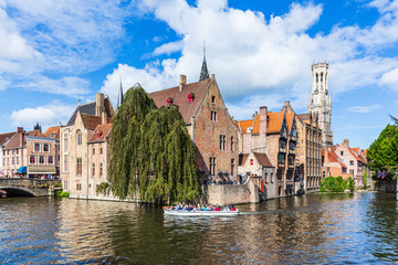 Fototapeta na wymiar Bruges, Belgium. The Rozenhoedkaai canal in Bruges with the Belfry in the background.
