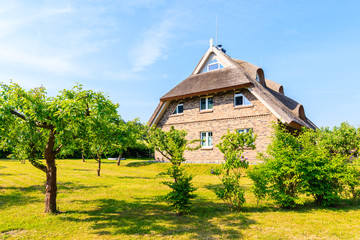 Typical red brick house with straw roof in Moritzdorf village, Baltic Sea, Germany