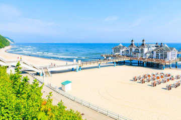 Sandy beach and famous Sellin Seebruecke (Sellin Pier) in summer, Ostseebad Sellin tourist resort, Baltic Sea, Germany