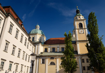 Obraz premium Clock and Bell tower with copper dome of St. Nicholas Catholic church Ljubljana Cathedral from Pogacar Square Ljubljana Slovenia