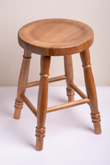 Handcrafted wooden backless stool on white background isolated