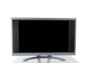Computer screen monitor isolated on white background with reflection on table