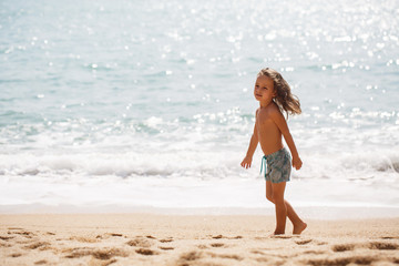 Cute boy is having fun on the beach 