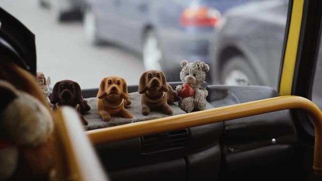 Toy dog in the car waving his head