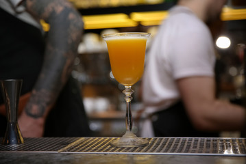 Fototapeta na wymiar Glass of tasty cocktail on bar counter