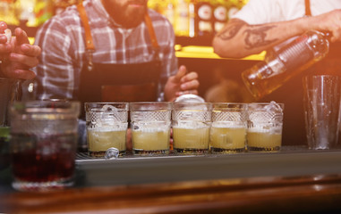 Glasses of tasty cocktail on bar counter