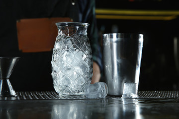 Professional barman equipment for making cocktails on counter in pub