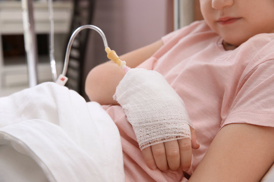 Little Child With Intravenous Drip In Hospital Bed, Closeup