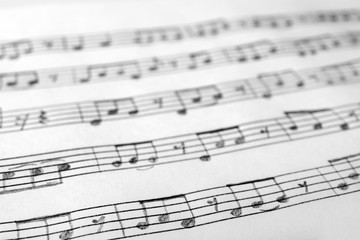 Sheet with music notes as background, closeup