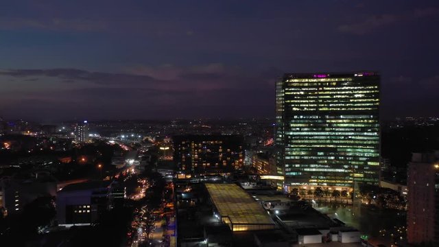 sunset night illuminated flight over bangalore cityscape wtc building traffic street aerial panorama 4k india