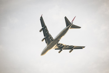 Fototapeta na wymiar big passenger Airplane from below flying away