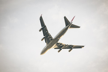 big passenger Airplane from below flying away