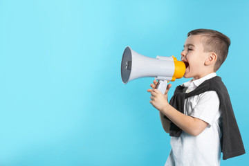 Cute funny boy with megaphone on color background. Space for text