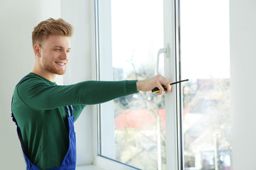 Fototapeta na wymiar Service man measuring window for installation indoors