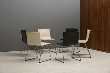 Chairs prepared for group therapy session in office. Meeting room interior