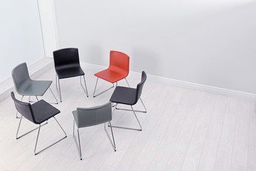Chairs prepared for group therapy session in office, space for text. Meeting room interior