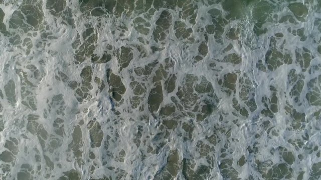 Aerial footage over waves washing up on the beach on the west coast of south africa