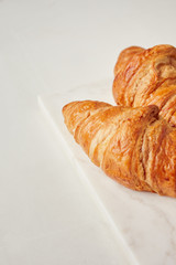 Croissants on the white marble board