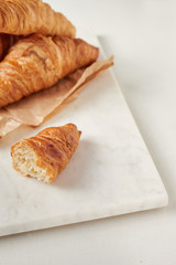 Croissants on the parchment paper, on the marbel board