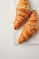 Croissants on the white marble board