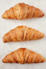 Croissants on the white marble board