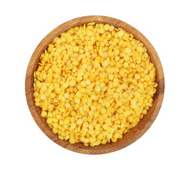 yellow lentil in wooden bowl isolated on white background. Top view