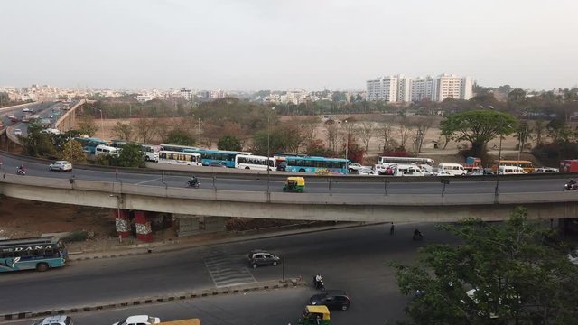 Wide angle panning motion lapse of traffic in KR Puram, Bengaluru, India during day time
