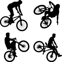silhouette of male doing bike trick