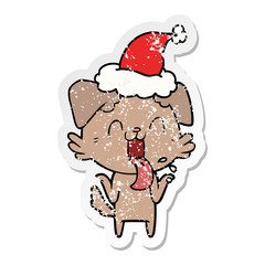 distressed sticker cartoon of a panting dog shrugging shoulders wearing santa hat