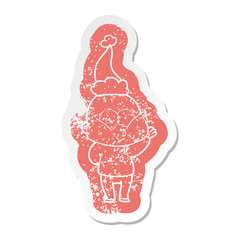 cartoon distressed sticker of a bald man staring wearing santa hat