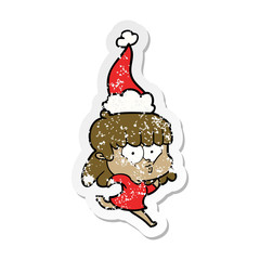 distressed sticker cartoon of a whistling girl wearing santa hat