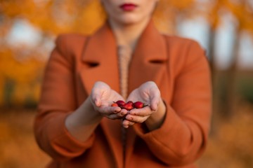 Girl holding rosehip
