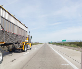 Rear and view of freight and cargo truck on Arizona highway.