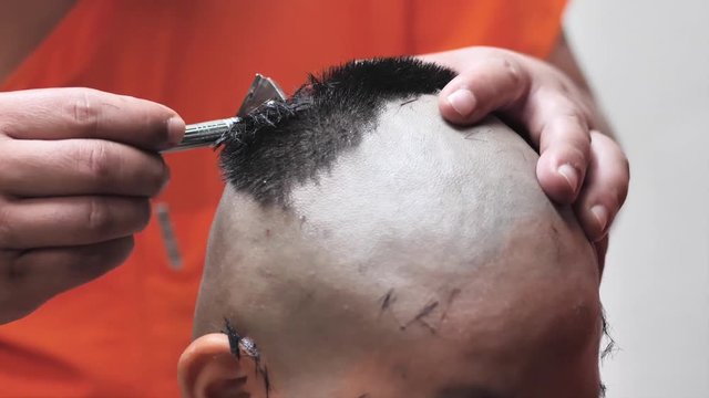 Monk in buddhism use clipper to shave the head pre novice. Thai culture, slow