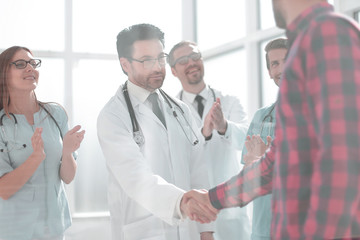 Thankful patient shaking doctors hand