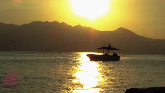 Captivating Sunset View of Subic Bay,  Philippines with Boats and Jet Ski in the Background